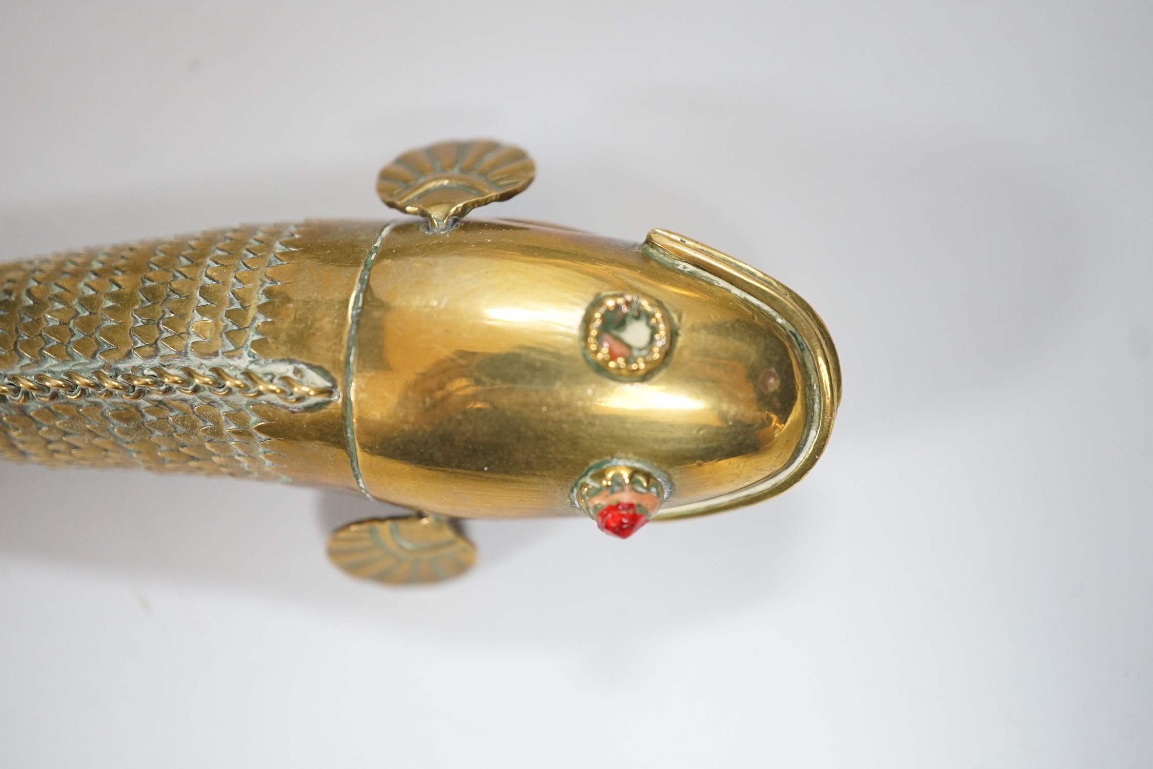 A set of three graduated brass articulated fish, largest 43.3cms long